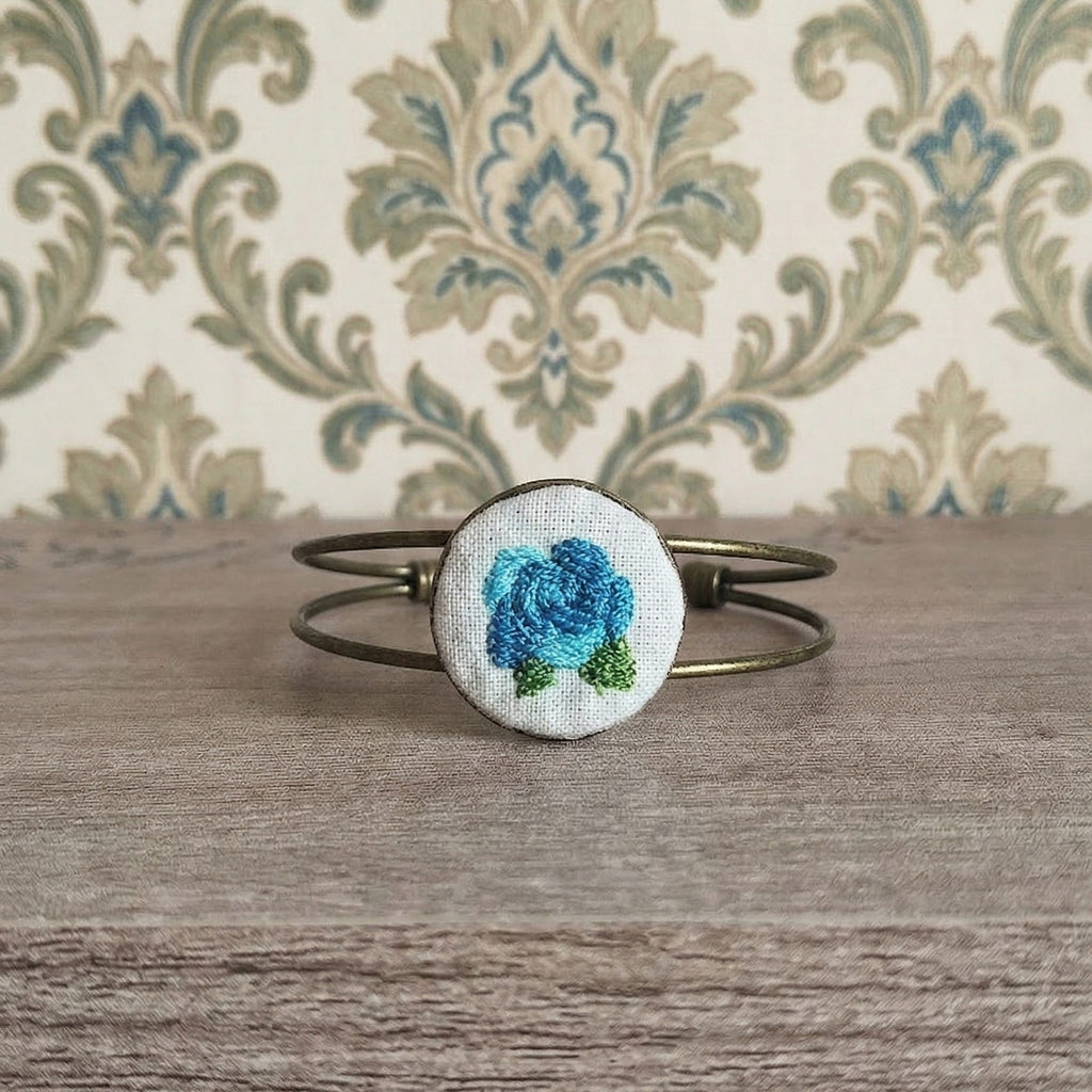 Bracciale artigianale Fildisogno con simbolo ricamato, elegante accessorio in tessuto con dettagli ricamati a mano.